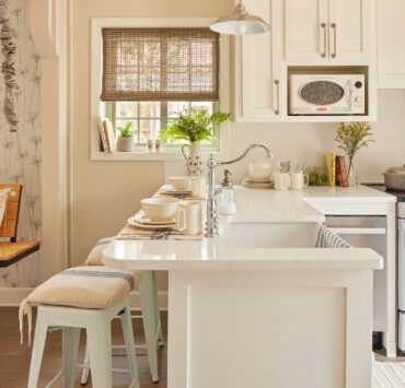 Kitchen with white countertops, cream walls and farmhouse style