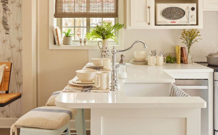 Kitchen with white countertops, cream walls and farmhouse style