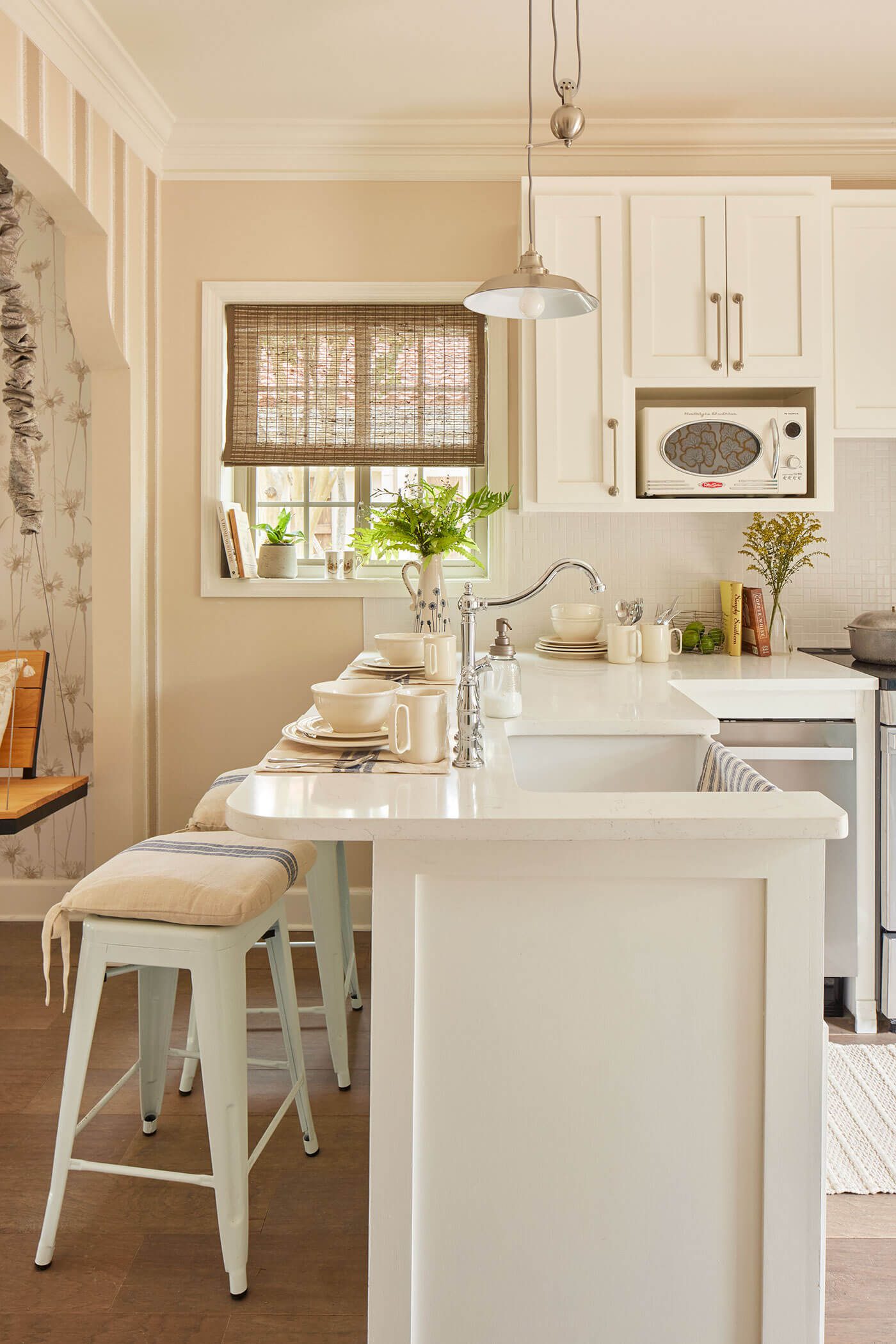 Kitchen with white countertops, cream walls and farmhouse style