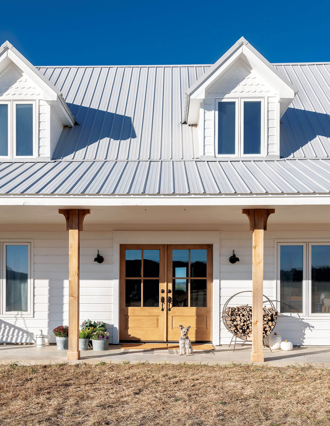 Farmhouse exterior with dog, for selling a home in the fall