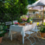 outdoor dining table set with flowers and summer watermelon and fried chicken