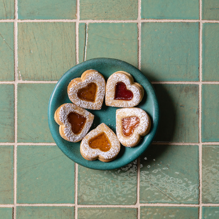 green square tile with plate of heart shaped cookies