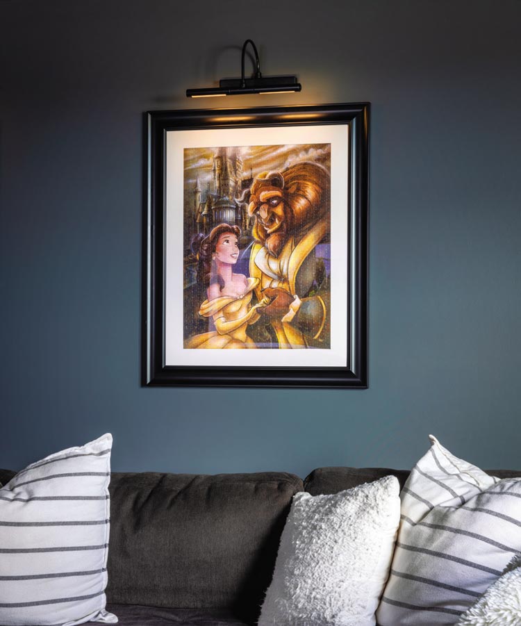framed Beauty and the Beast puzzle against a wall with dark gray mineral paint