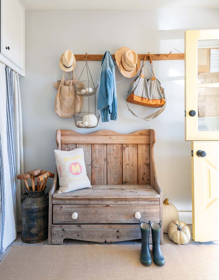 mudroom with vintage wooden bench and coat hooks