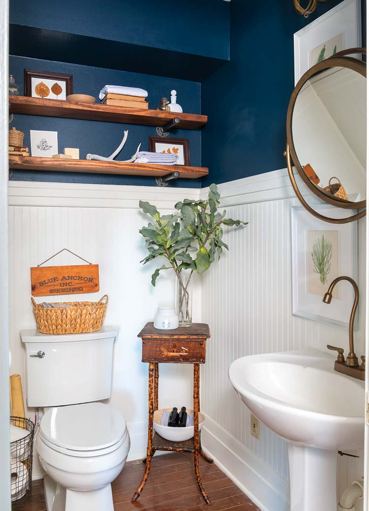 guest bathroom with wainscoting and navy blue walls