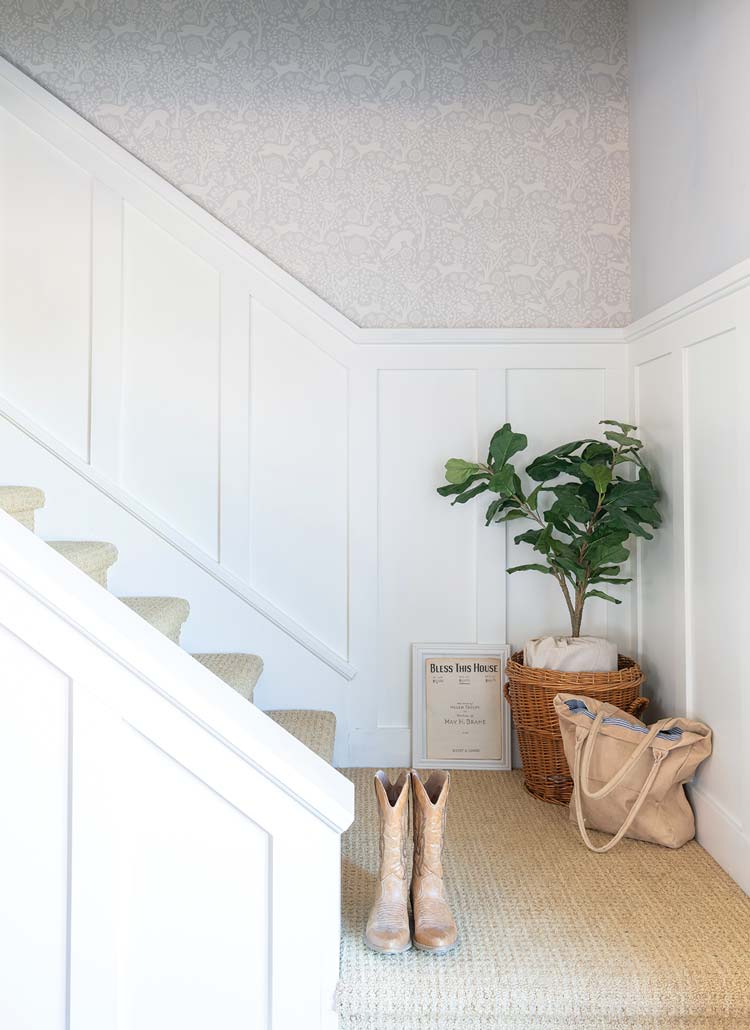 stairway with faintly patterned deer wallpaper