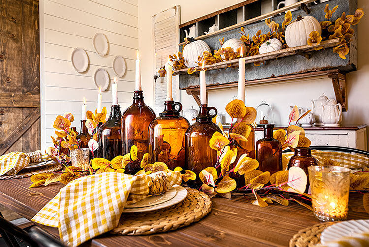 Close up of fall tablescape with vintage fall decor and amber bottles