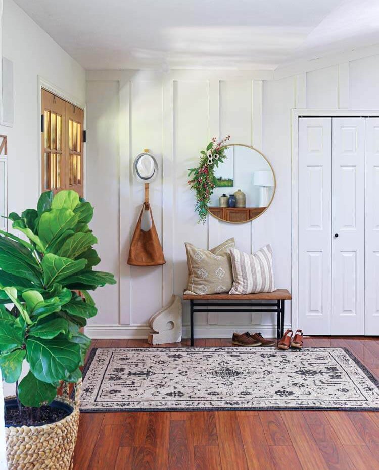 entryway with circular mirror and fiddleleaf fig