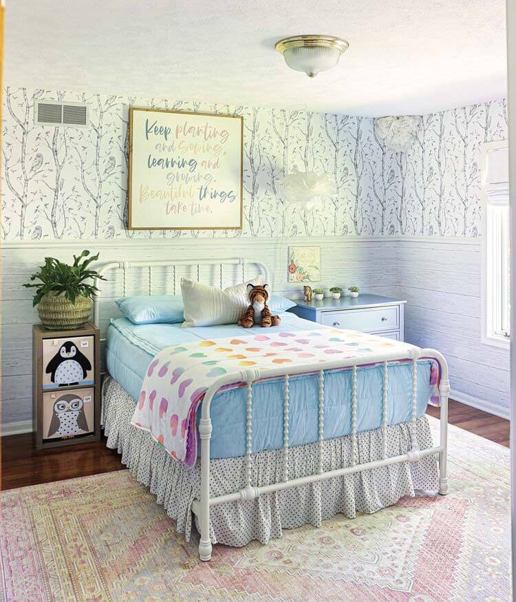 child's bedroom with black and white tree wallpaper