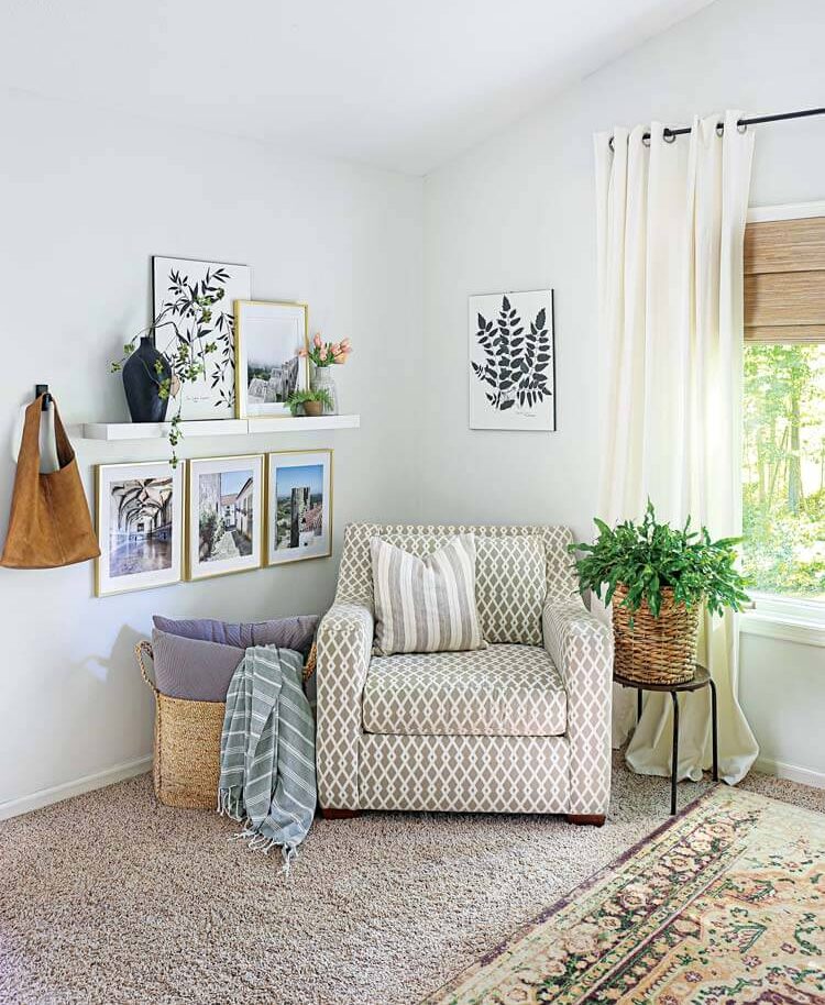 white reading nook with framed botanical prints and photographs