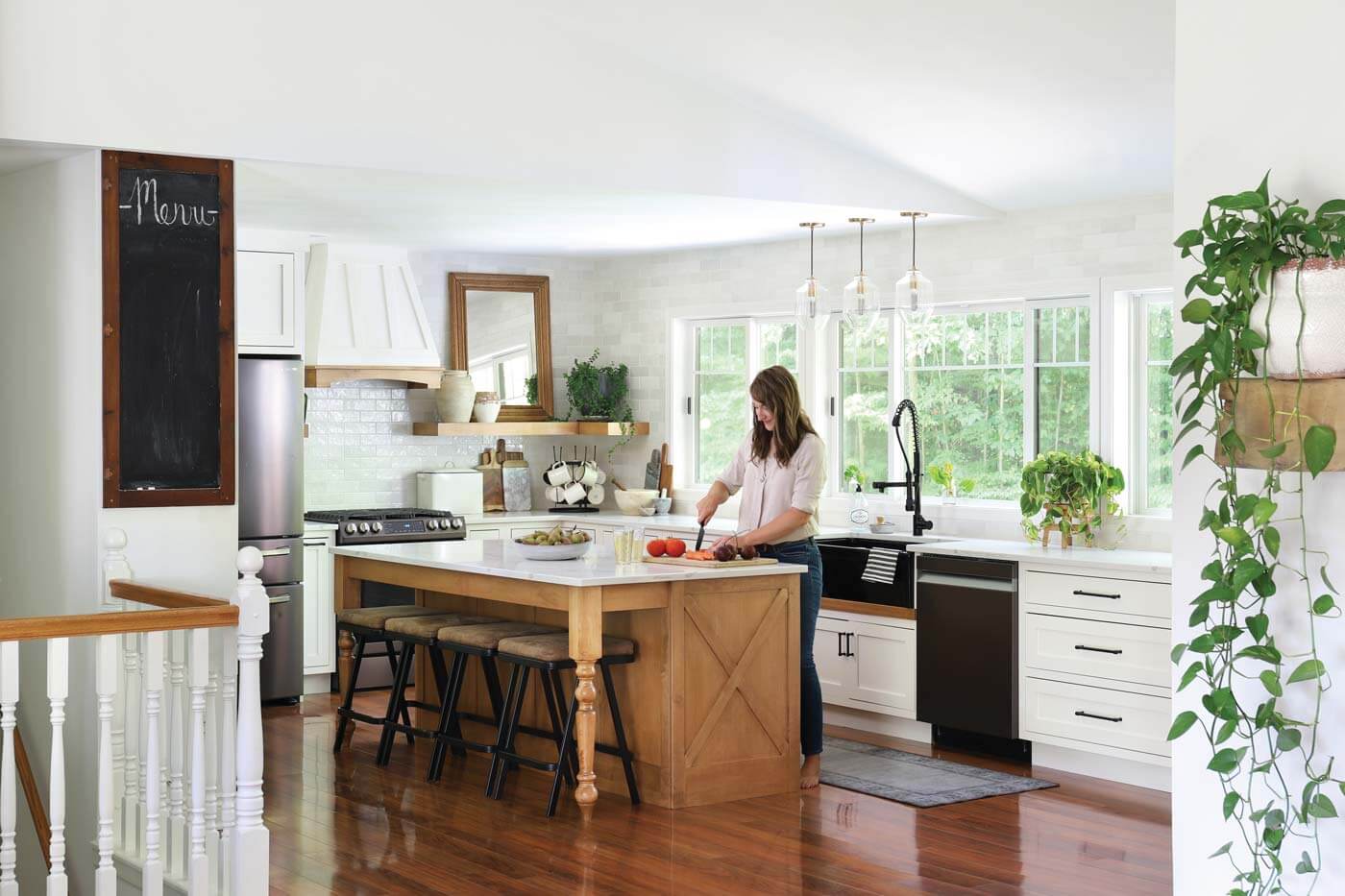 farmhouse white kitchen with wood island and white subway tile