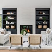 living room with built in shelves, fireplace and white couches