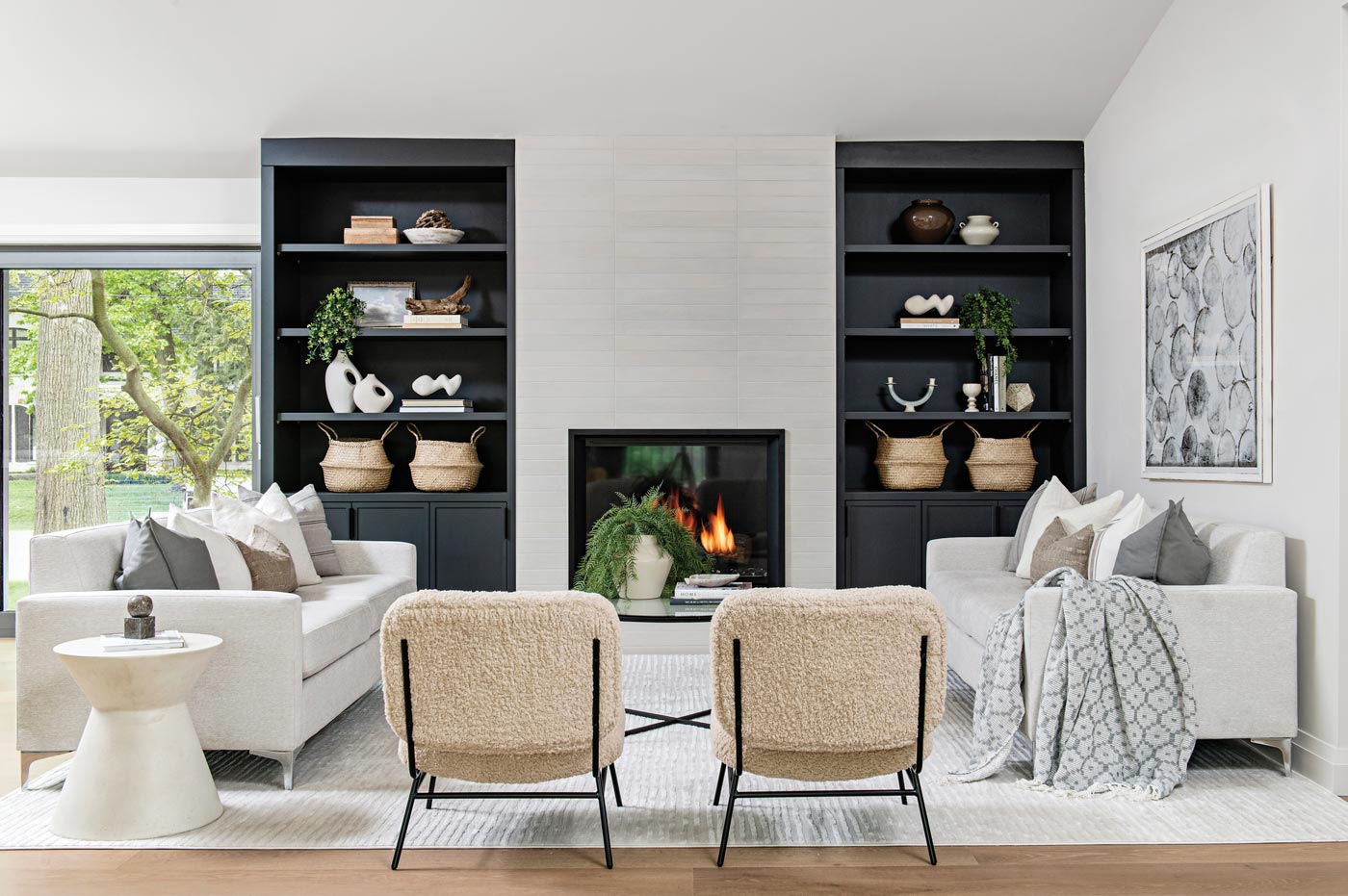 living room with built in shelves, fireplace and white couches