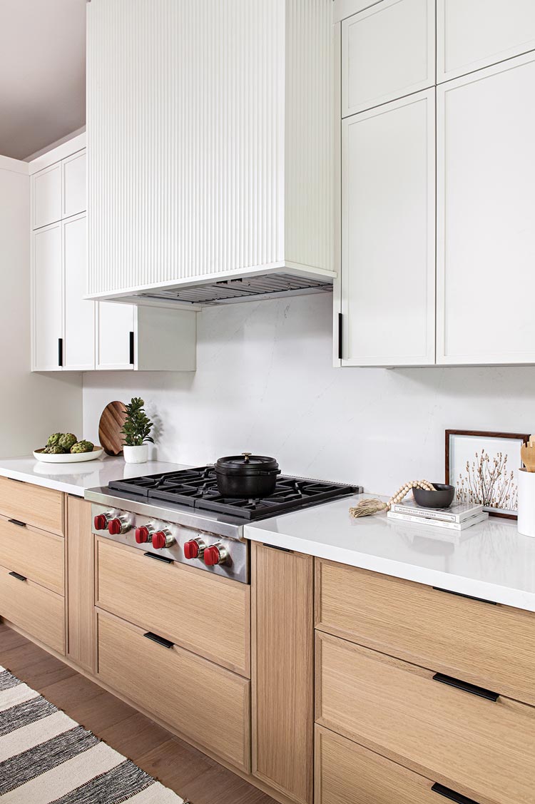 built in range and oven hood in neutral kitchen