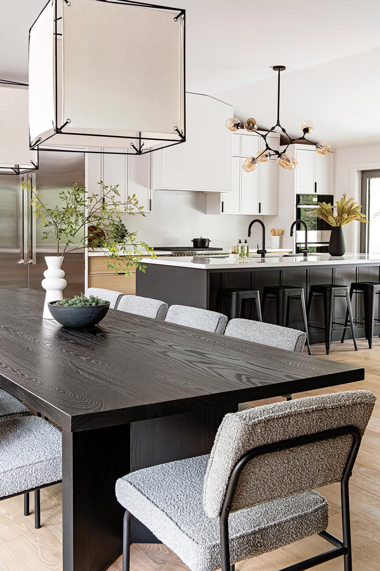 black dining table and island in Scandinavian style kitchen