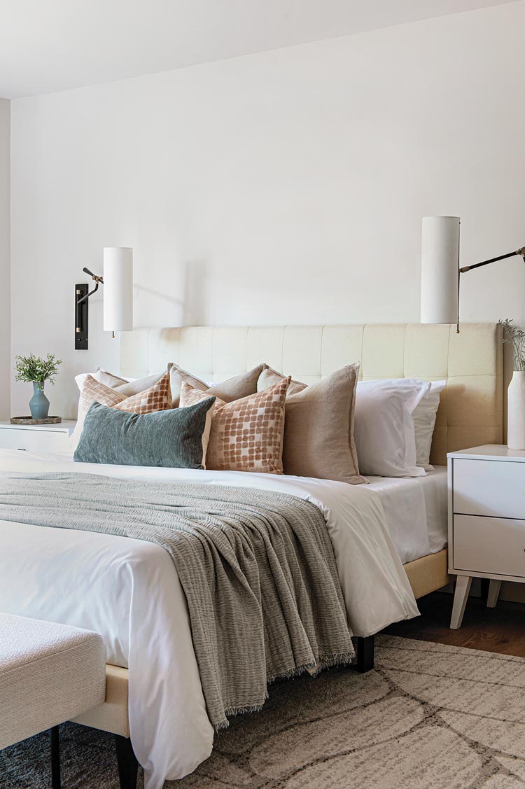 upholstered bed frame and layered bed in neutral bedroom
