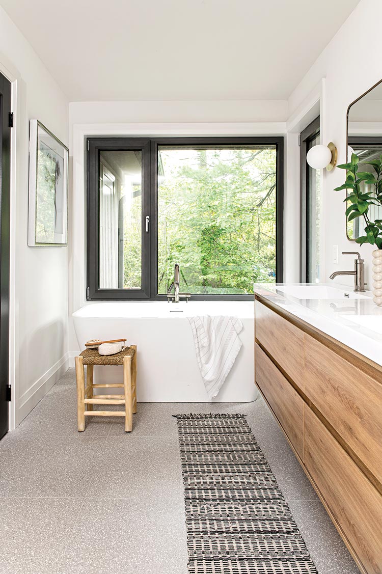 freestanding tub and black window frame in Scandinavian inspired Ontario home