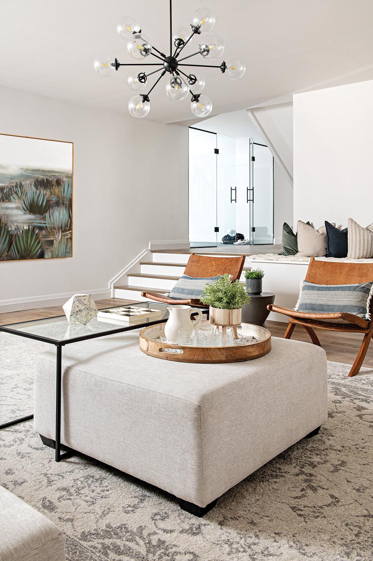 basement with high ceilings and neutral color scheme and sputnik style chandelier