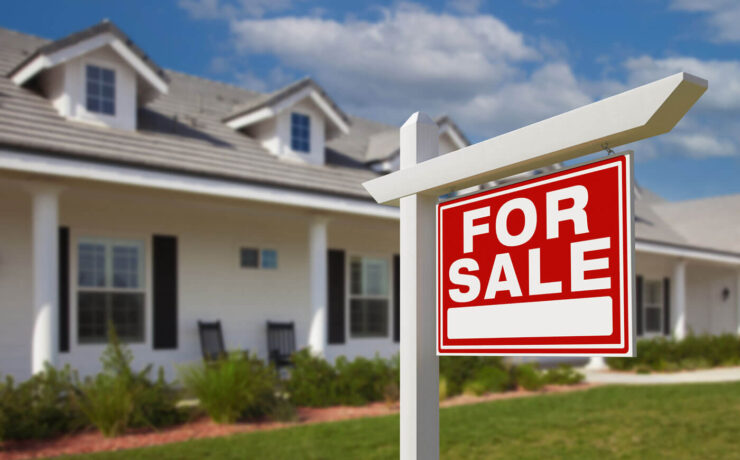 For sale sign outside farmhouse for selling a farmhouse