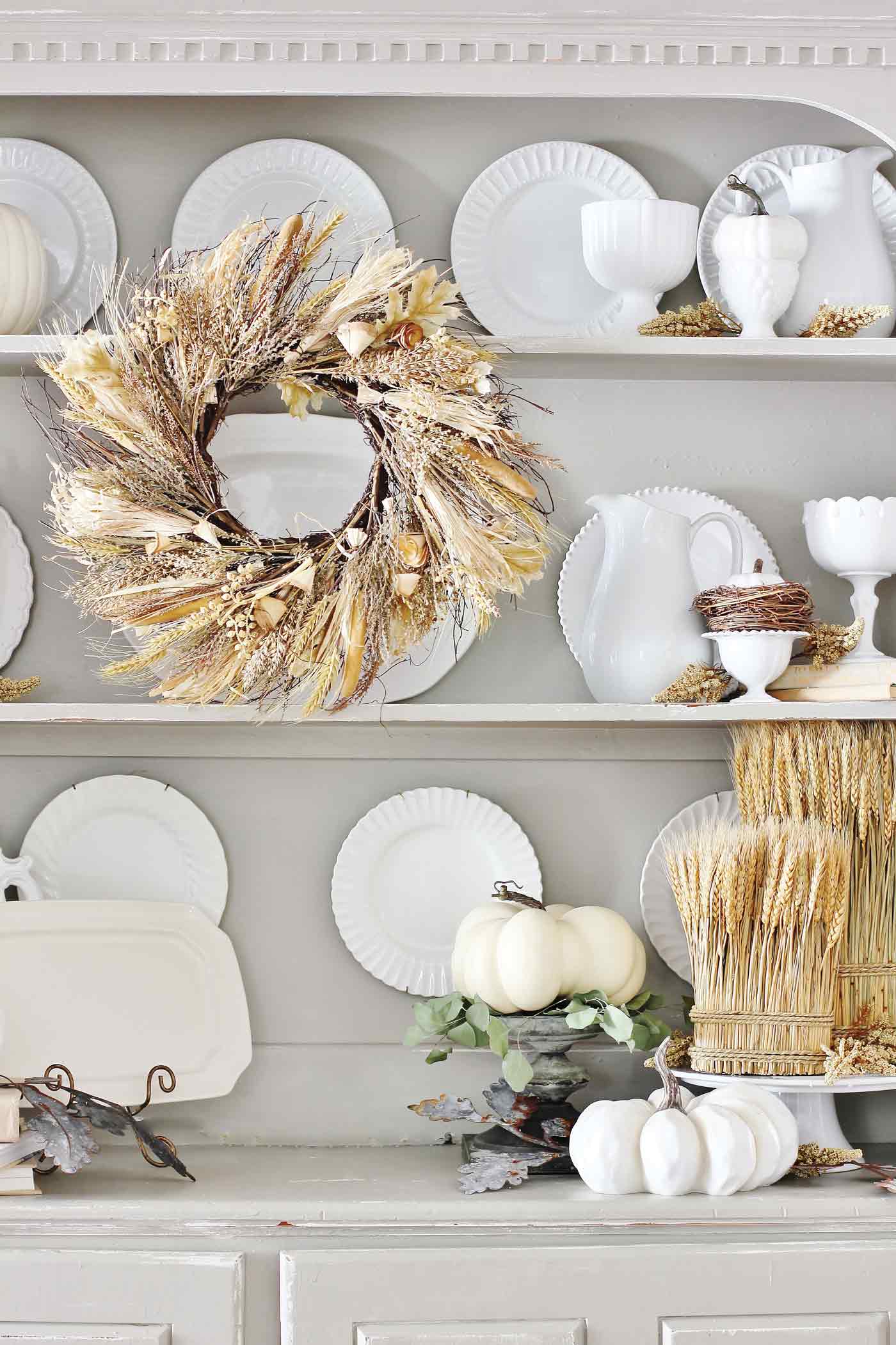 Bookshelf with pumpkins and wreath for easy fall decorating ideas