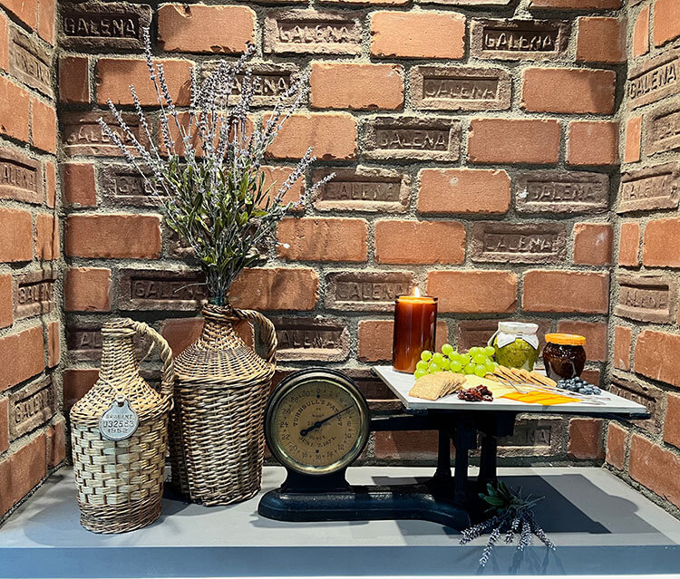 Brick dining room with antique scale serving a cheese platter