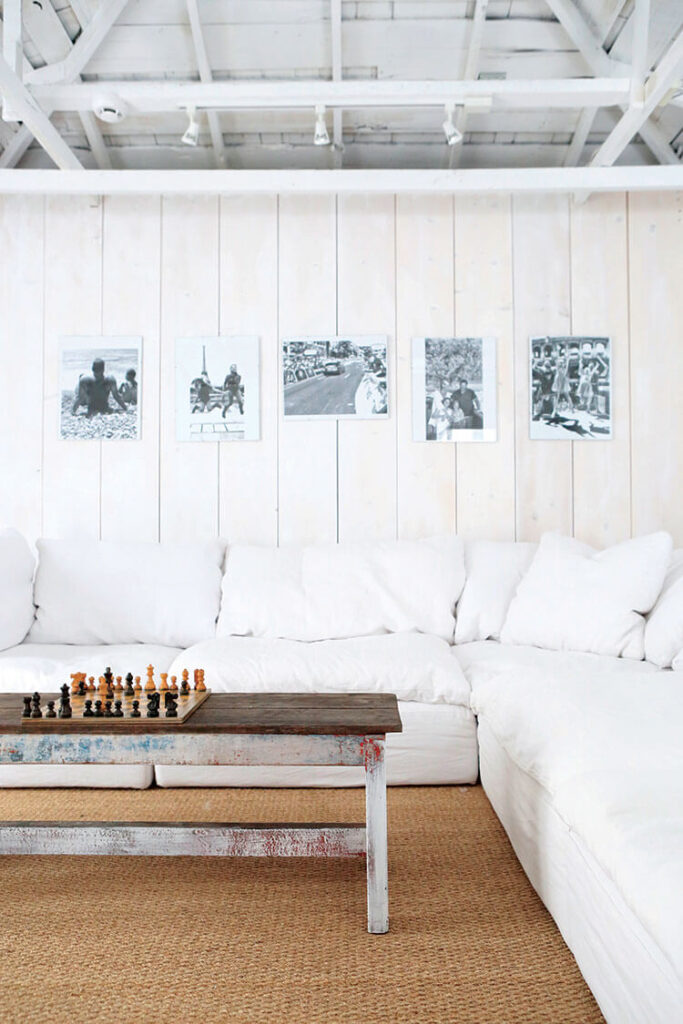 Barn home with white sofa and black and white art on the walls