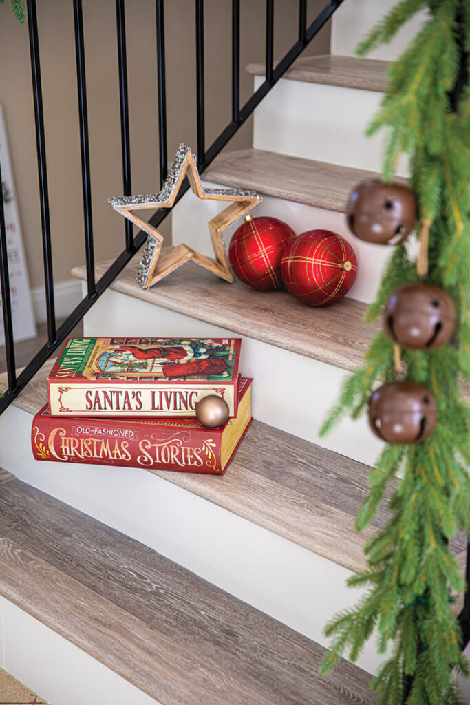 stair Christmas vignette with wooden star and vintage Christmas books
