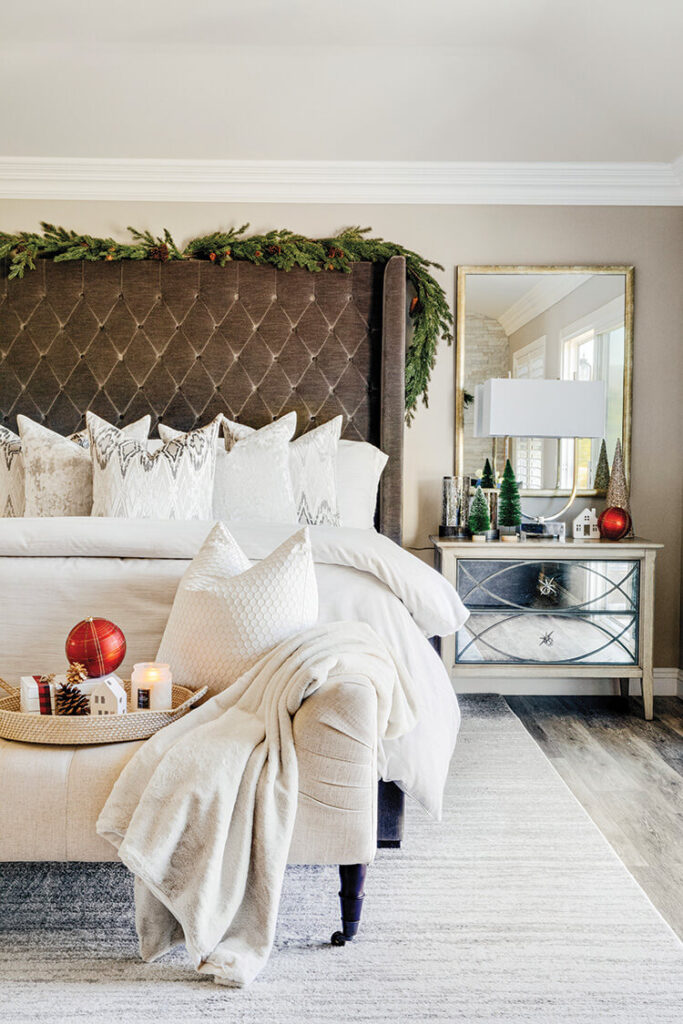 primary bedroom with garland on top of oversized headboard