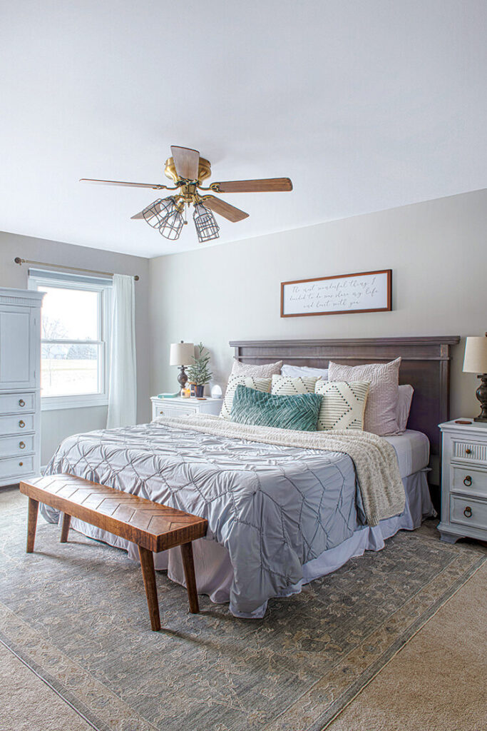 primary bedroom with layered bedding in Michigan farmhouse