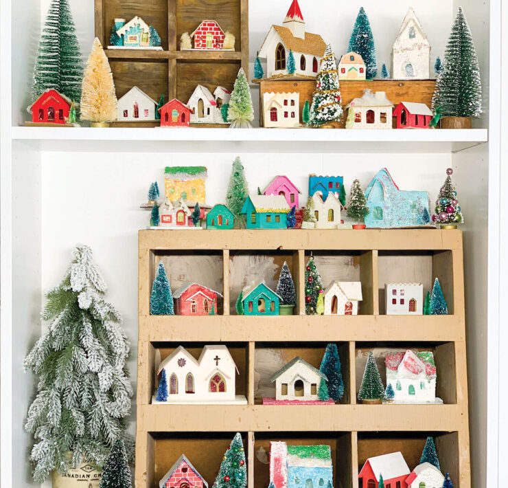 village of Christmas putz houses in wooden shelf
