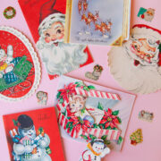 Vintage Christmas postcards against a pink background