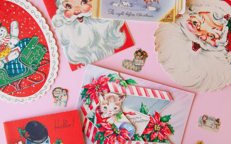 Vintage Christmas postcards against a pink background