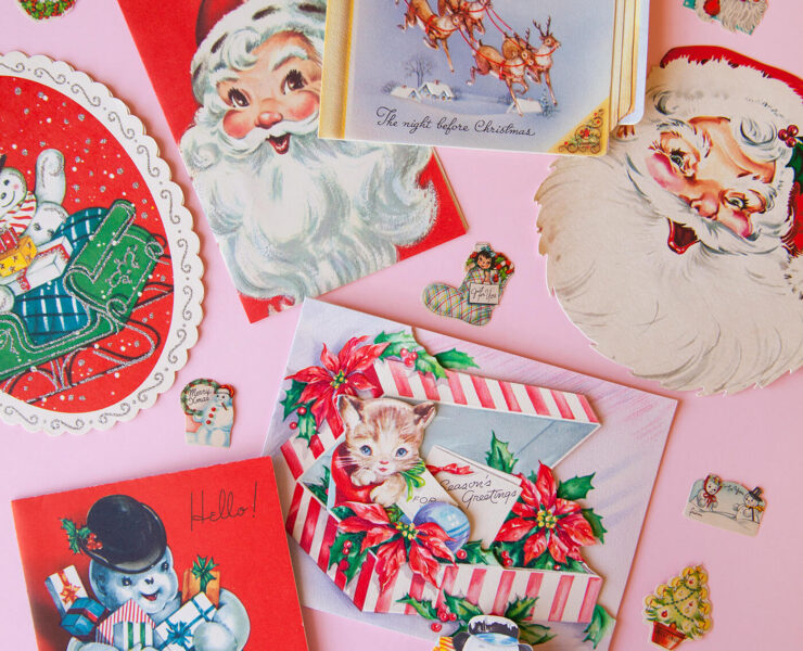 Vintage Christmas postcards against a pink background