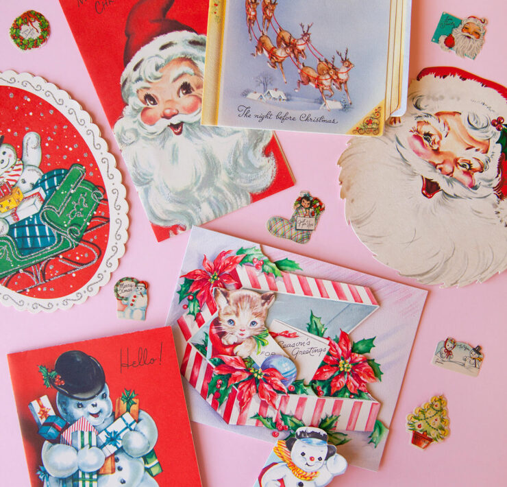 Vintage Christmas postcards against a pink background