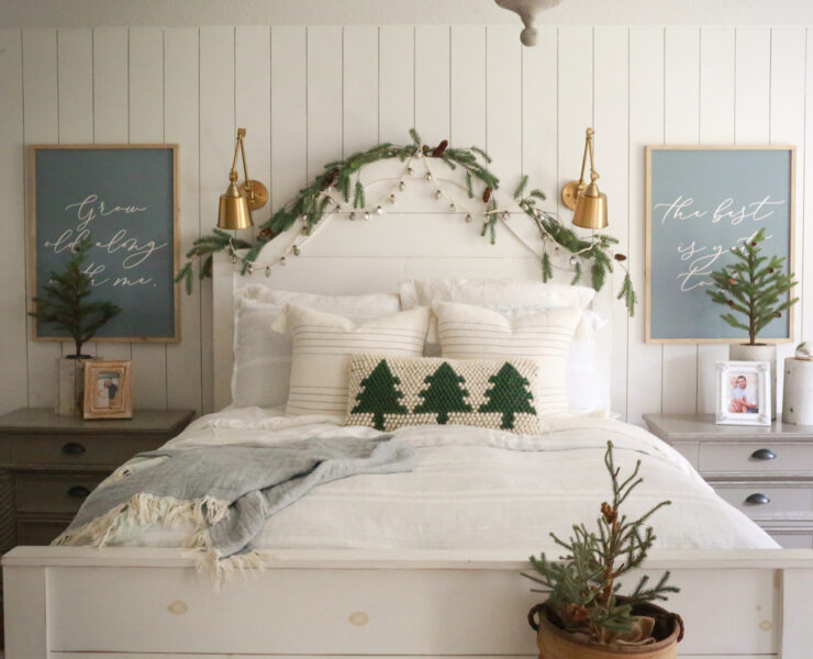 small potted trees and greenery garland in primary bedroom