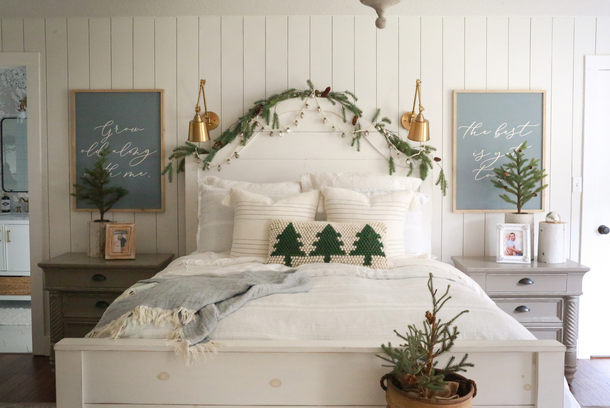 small potted trees and greenery garland in primary bedroom