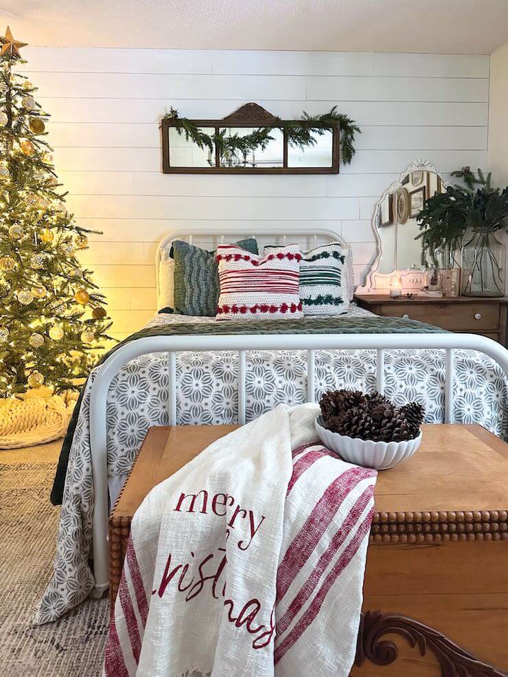 throw blanket, Christmas tree, fresh greens and layered bedding in guest bedroom