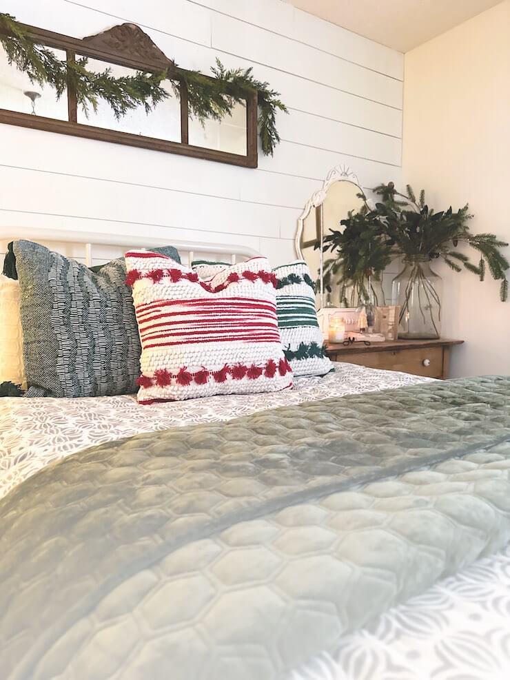 throw pillows and fresh greenery in holiday guest room