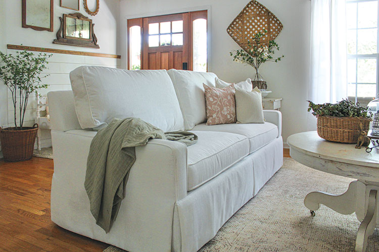 profile view of white customized farmhouse sofa