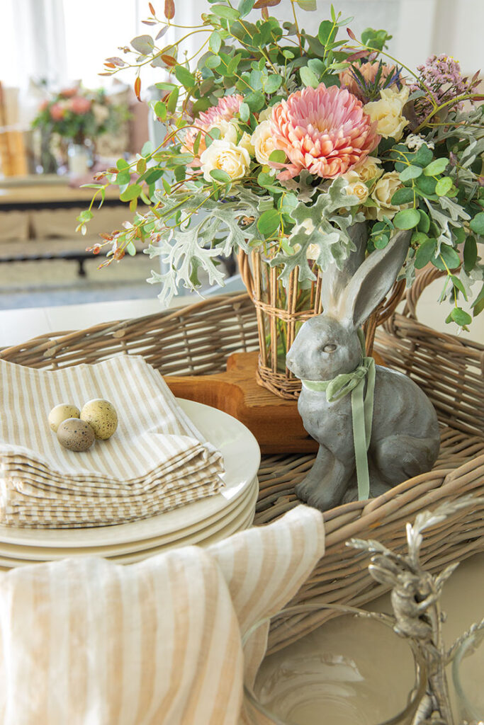Tabletop style spring decor with bunny, plates, napkins, fresh flowers and birds eggs