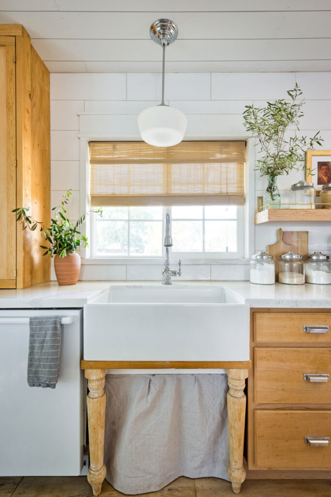 Apron front sink in open kitchen with small space tips storage underneath