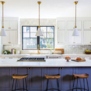 blue cabinetry on island in modern farmhouse style kitchen