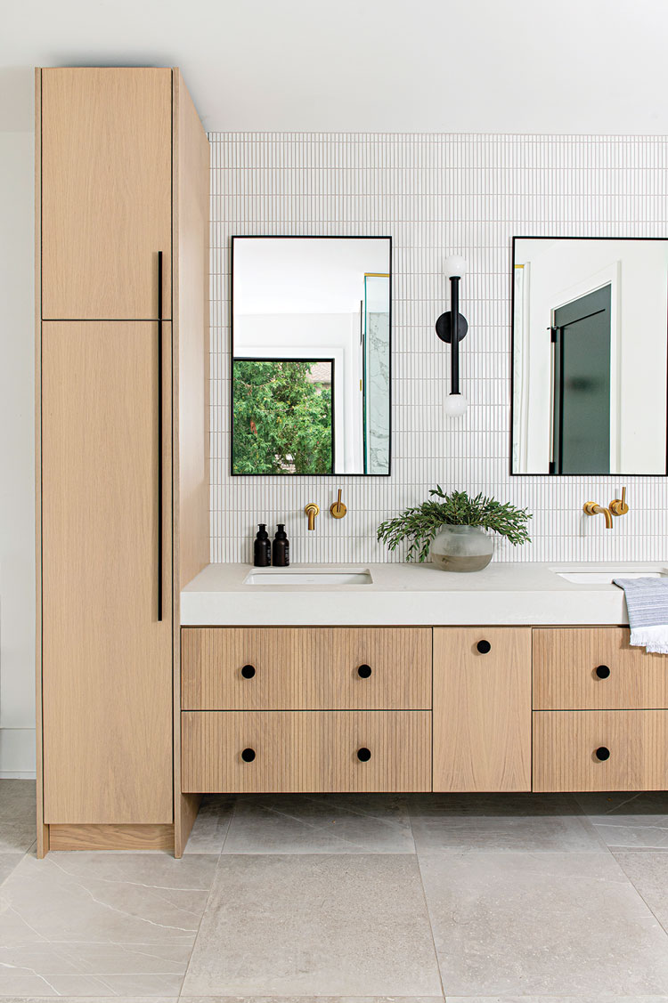 bathroom with subtle linear porcelain tile and white oak cabinets