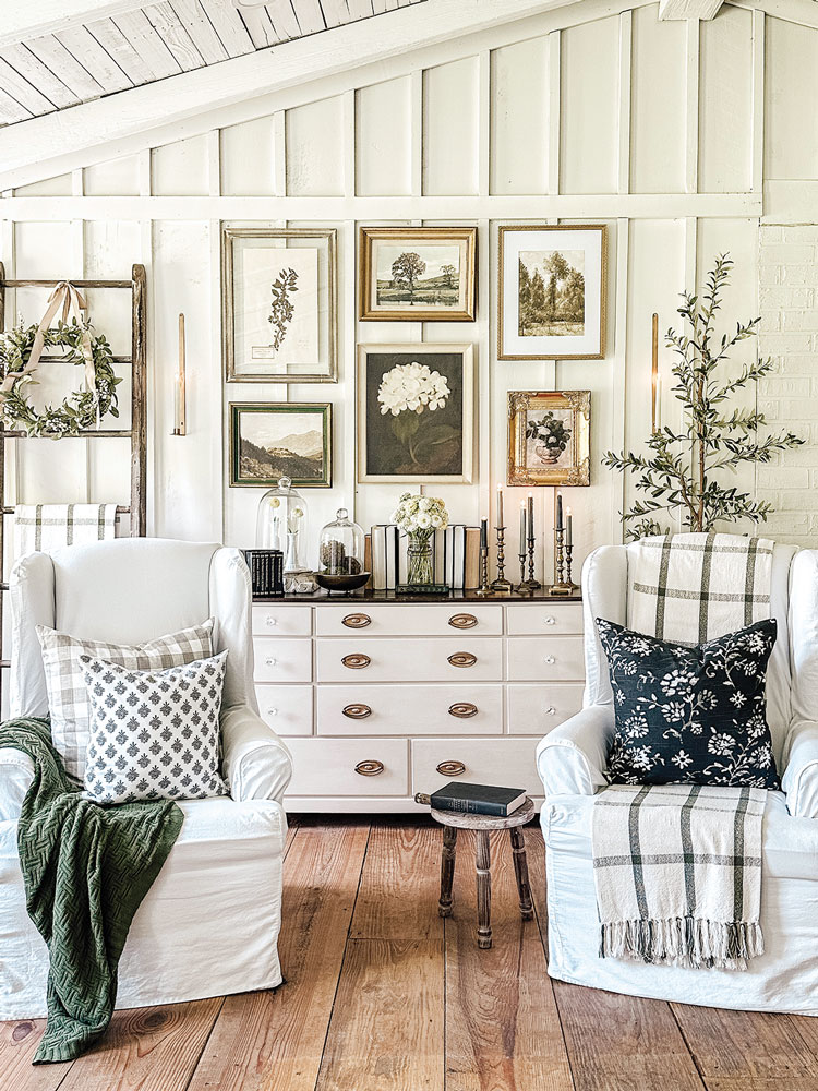 throw blankets on white wingback chairs and gallery wall
