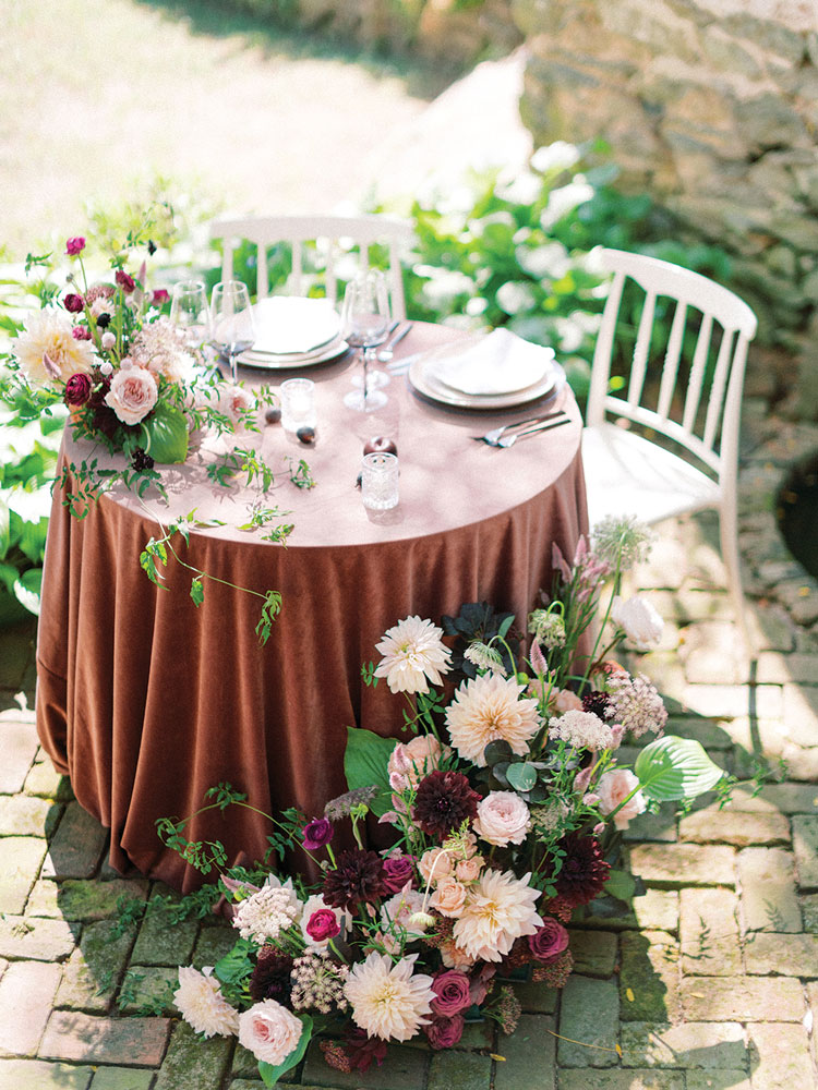 two bouquets of flowers at table for two