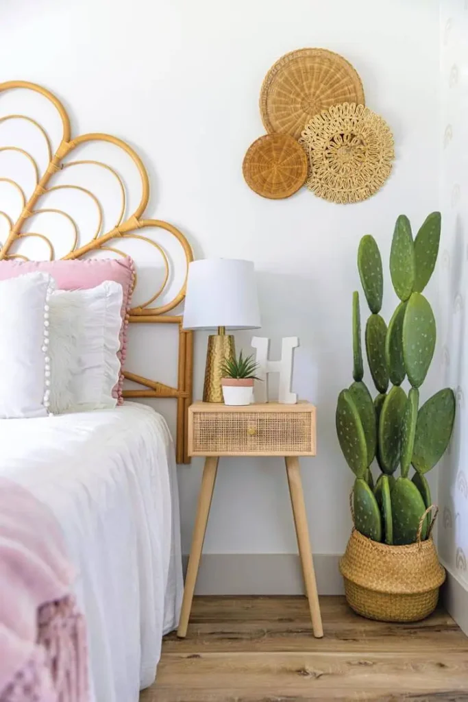 rattan headboard and nightstand and woven baskets with textured pillows and lamp