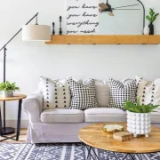 boho farmhouse living room with geometric rug and throw pillows and wood furniture