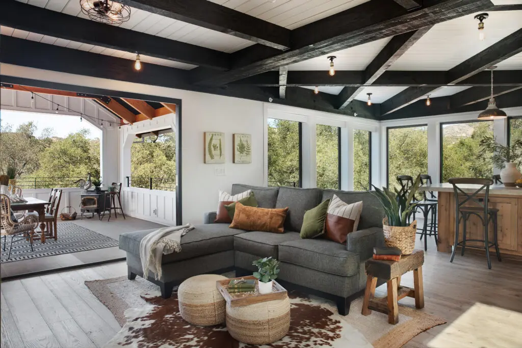 modern califronia farmhouse living room with high contrast wood beams and white ceiling and walls
