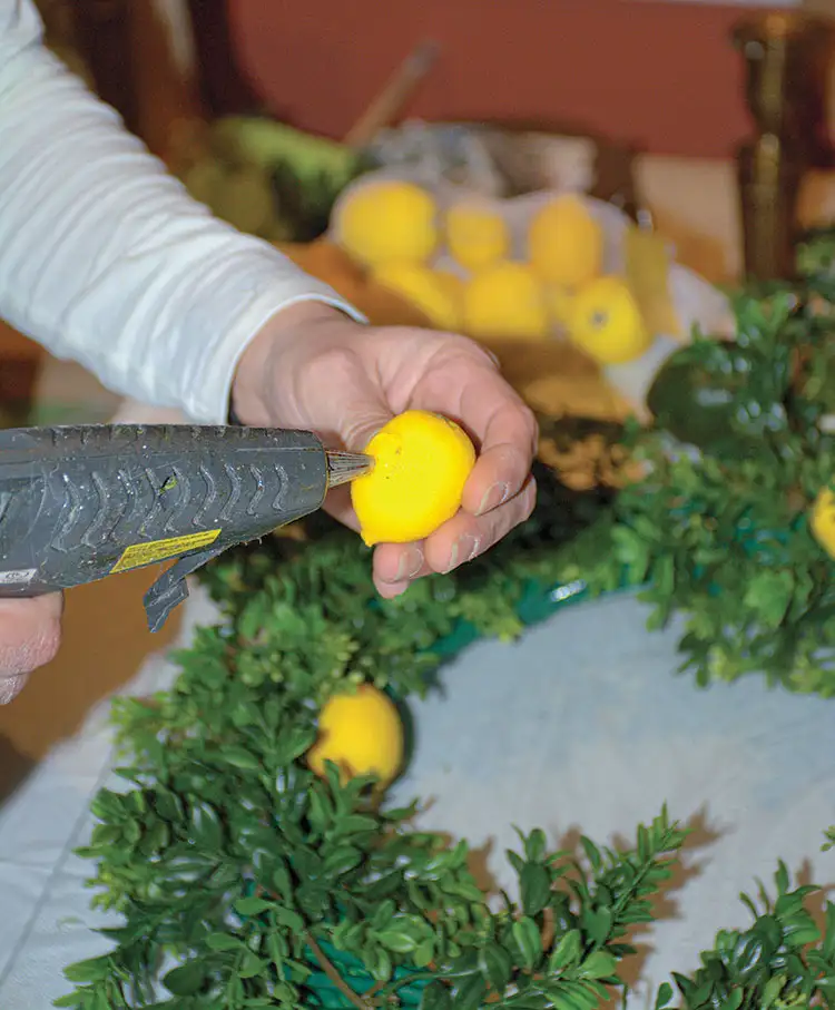 hot gluing lemons for wreath