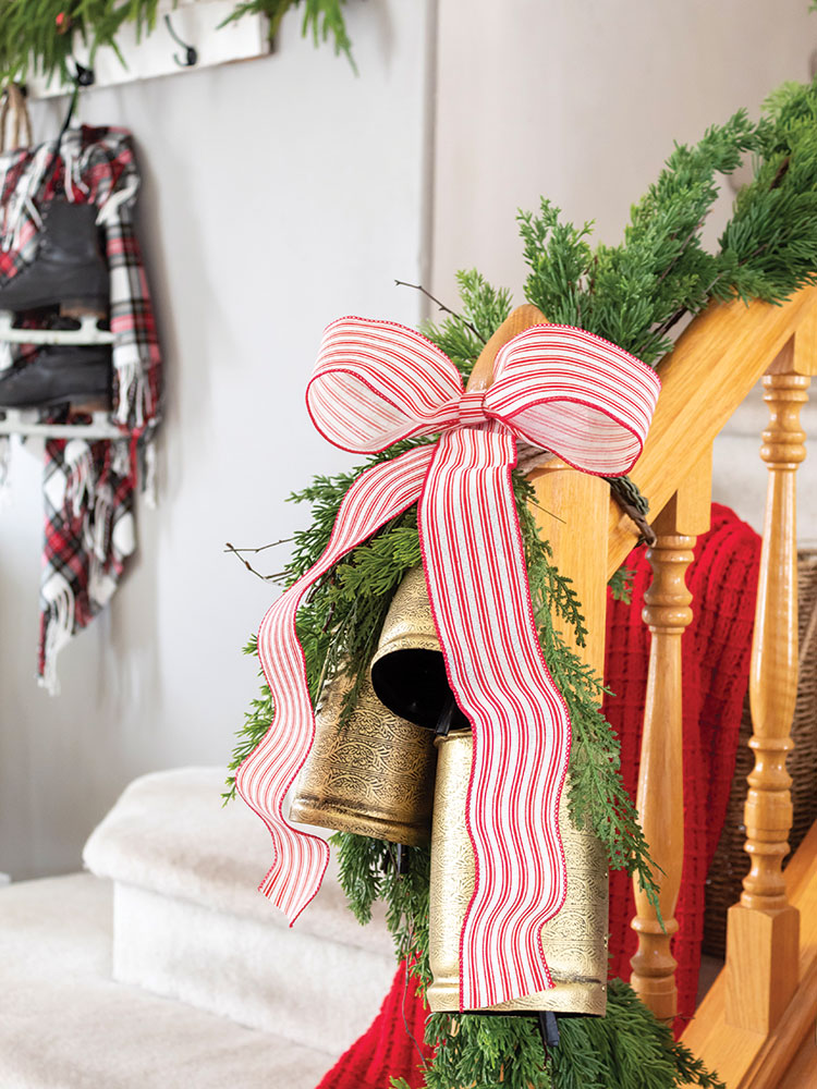 red and white striped ribbon at the end of banister garland